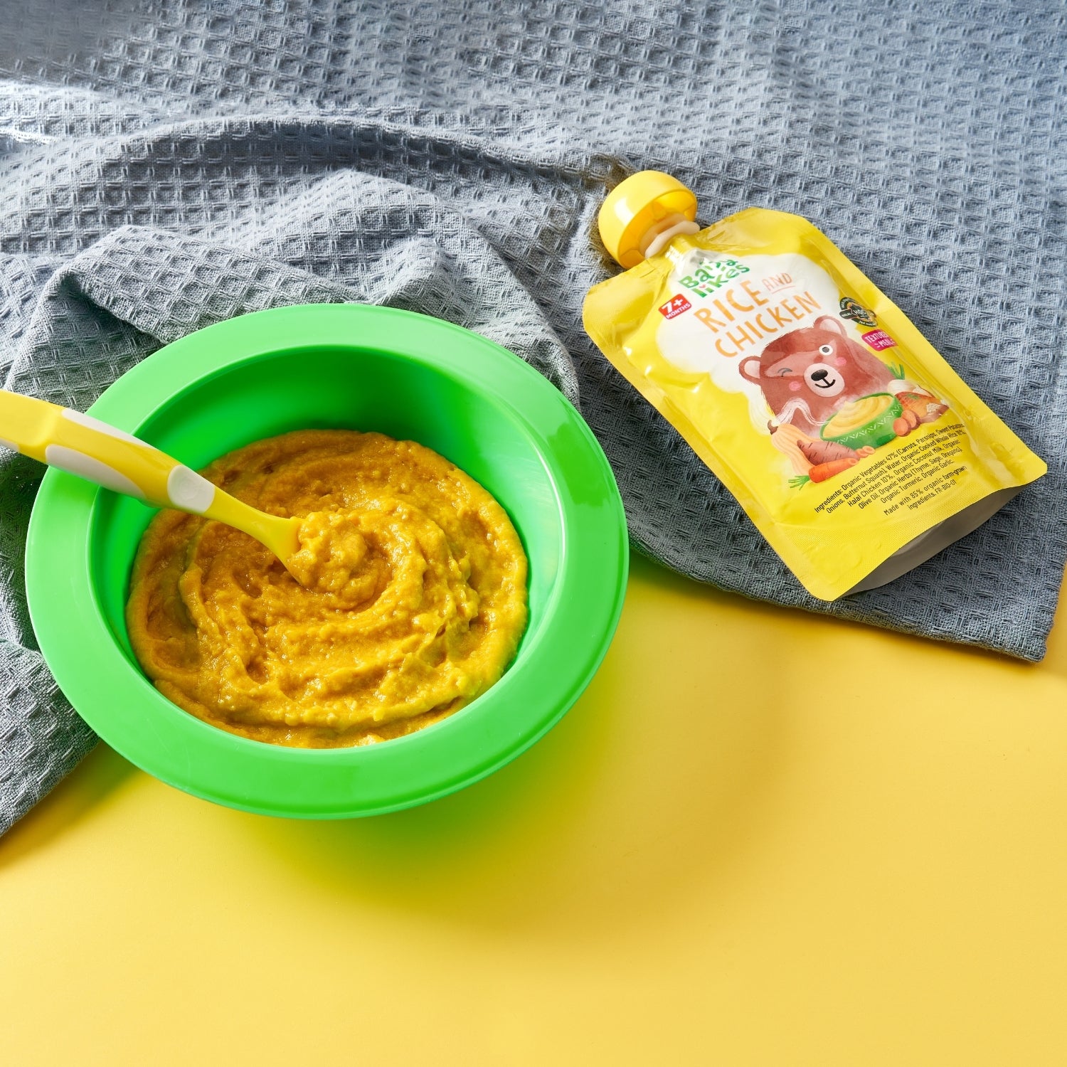 Bowl of Baby Likes Rice and Chicken puree alongside cooked organic rice, highlighting nutritious, energy-rich halal baby food with natural ingredients